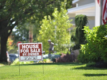 For sale sign outside of a house.