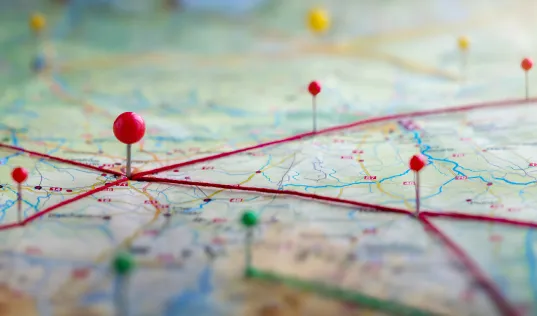 map with a bunch of pins in it connected with string