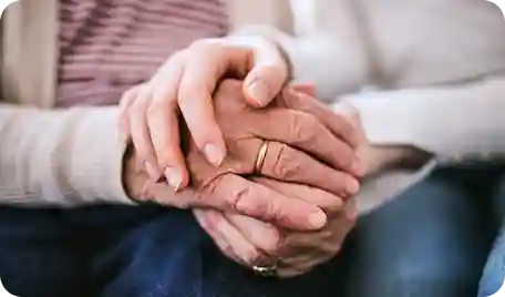 A couple holding hands after being approved for real estate financing