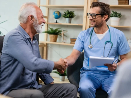 Healthcare professional shaking the hand of patient