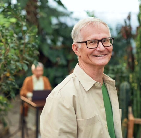 Man smiling, standing outside